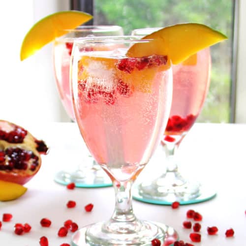 Spritzer made with mango pomegranate fruit infused vodka