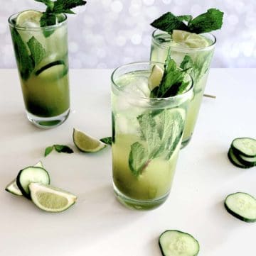 Naturally green cucumber gin cocktail with lime and mint garnish in a highball glass