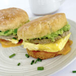 Gluten free breakfast sandwiches on a plate with tea.