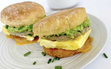 Gluten free breakfast sandwiches on a plate with tea.
