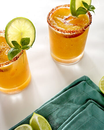 Two Hot Honey Peach Margaritas and blue napkin