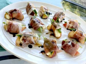 Peach and Prosciutto Appetizers outside on a patio table