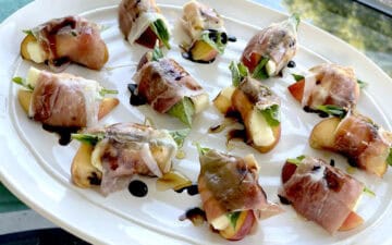 Peach and Prosciutto Appetizers outside on a patio table