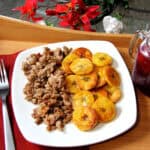 Ground sausage and fried plantains served with unsweet fruity black tea in mason jar.