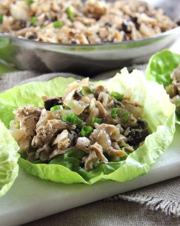 Chicken Lettuce Wraps with filling in bowl behind them