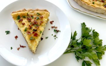 Gluten Free Quiche Lorraine on plate with parsley and quiche plate next to it